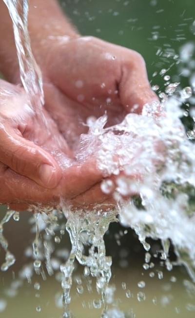 water flowing over hands